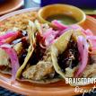 a plate of braised pork belly tacos with salsa